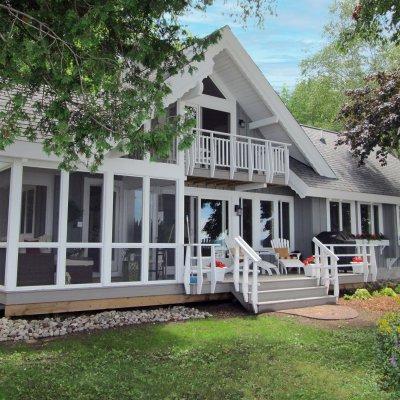 Lake side of cottage with screened porch 